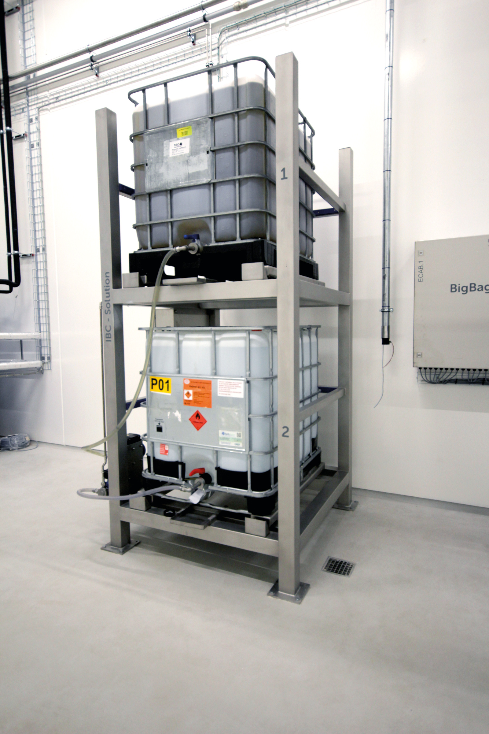 NIO WHF-Anlage mit zwei übereinander angeordneten IBCs und angeschlossenen Produktschläuchen
